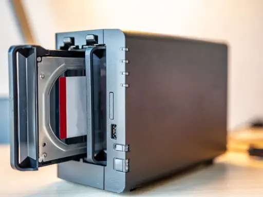 Un NAS avec un disque dur inséré. Ce support permet de sauvegarder ses données informatiques, contrairement à une simple clé USB.