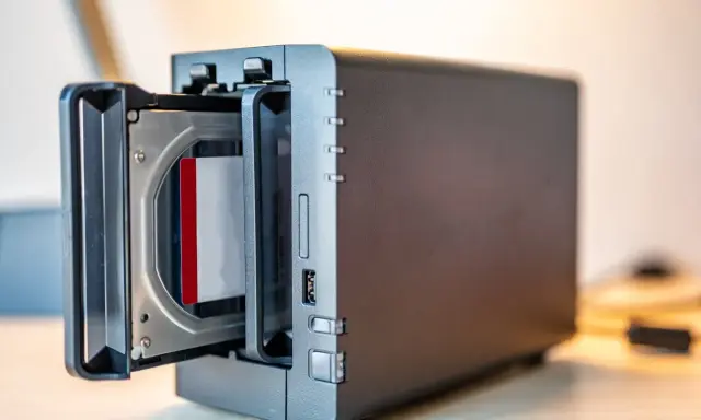Un NAS avec un disque dur inséré. Ce support permet de sauvegarder ses données informatiques, contrairement à une simple clé USB.